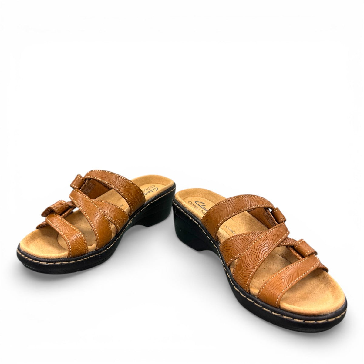 Clarks Merliah Karli tan leather sandal with a mid-height heel, riptape straps, and comfort footbed.
front view.