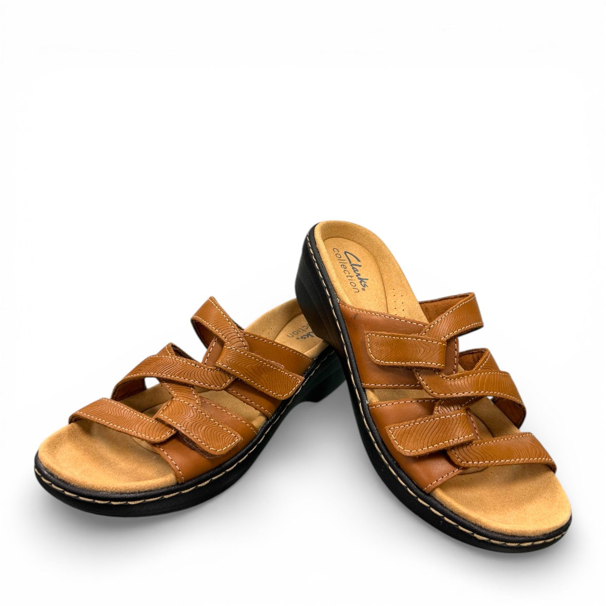 Clarks Merliah Karli tan leather sandals with adjustable riptape straps and a comfortable mid-height heel. front view.