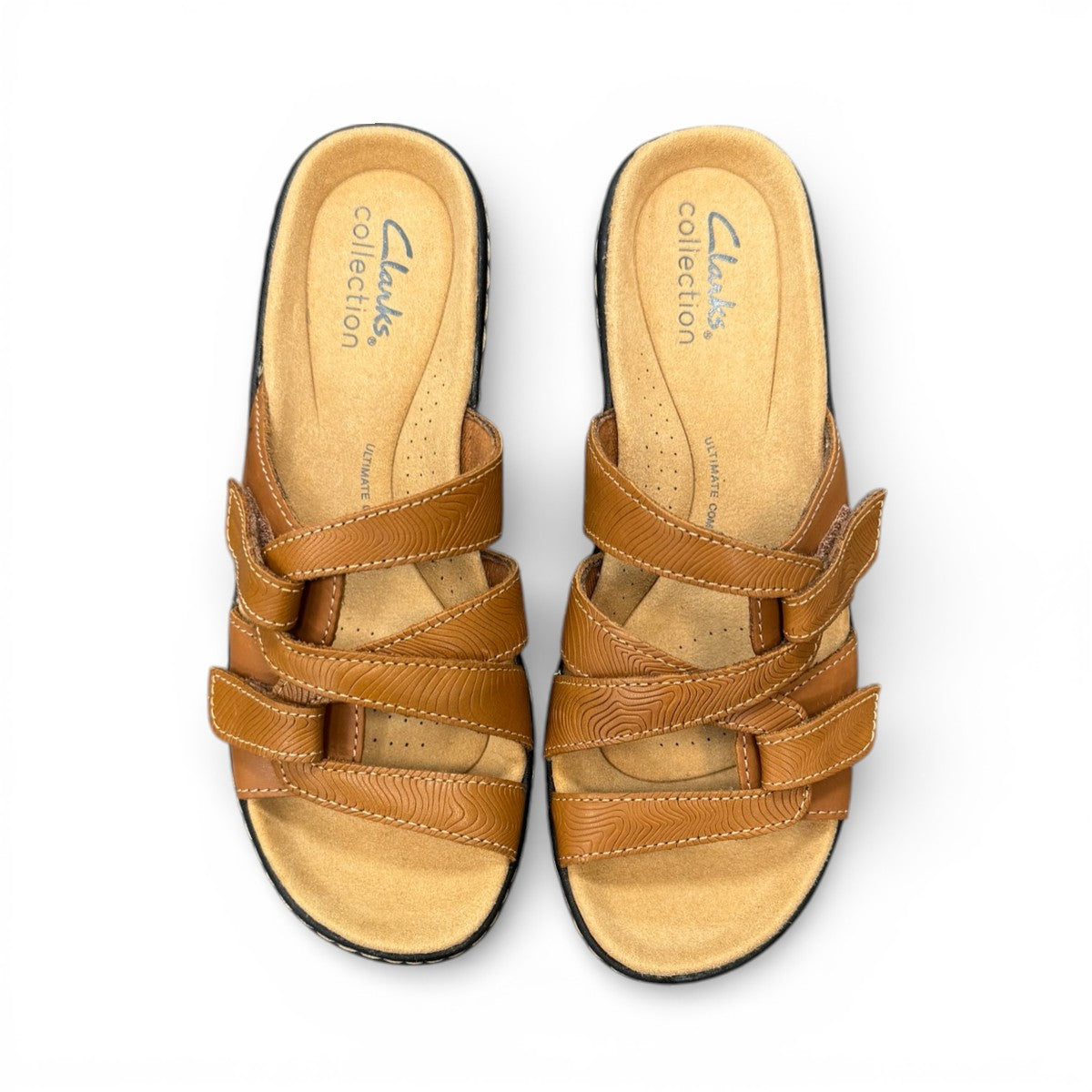Clarks Merliah Karli tan leather sandal with a mid-height heel, riptape straps, and comfort footbed.
top view.