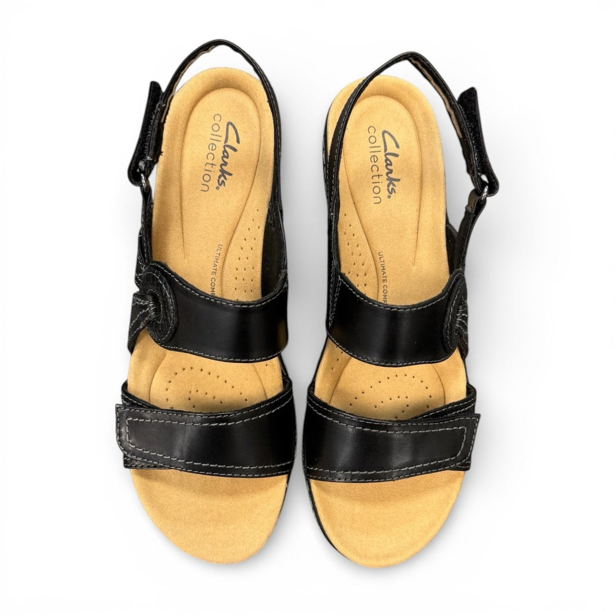 Clarks Merliah Opal black leather wedge sandals with adjustable straps and perforated detailing. top view.