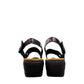 Clarks Merliah Opal black leather wedge sandals with adjustable straps and perforated detailing. back view.