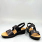 Clarks Merliah Opal black leather wedge sandals with adjustable straps and perforated detailing. front view.