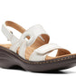 Clarks Merliah Opal white leather wedge sandals with adjustable straps and cushioned insole. front view.