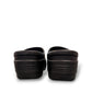 Dansko Kaci black molded EVA clogs showing the slip-resistant rubber outsole tread pattern