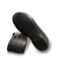 Dansko Kaci black molded EVA clogs showing the slip-resistant rubber outsole tread pattern. Photo of bottom view.