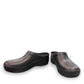 Dansko Kaci black molded EVA clogs showing the slip-resistant rubber outsole tread pattern. Photo of front view from an angle.