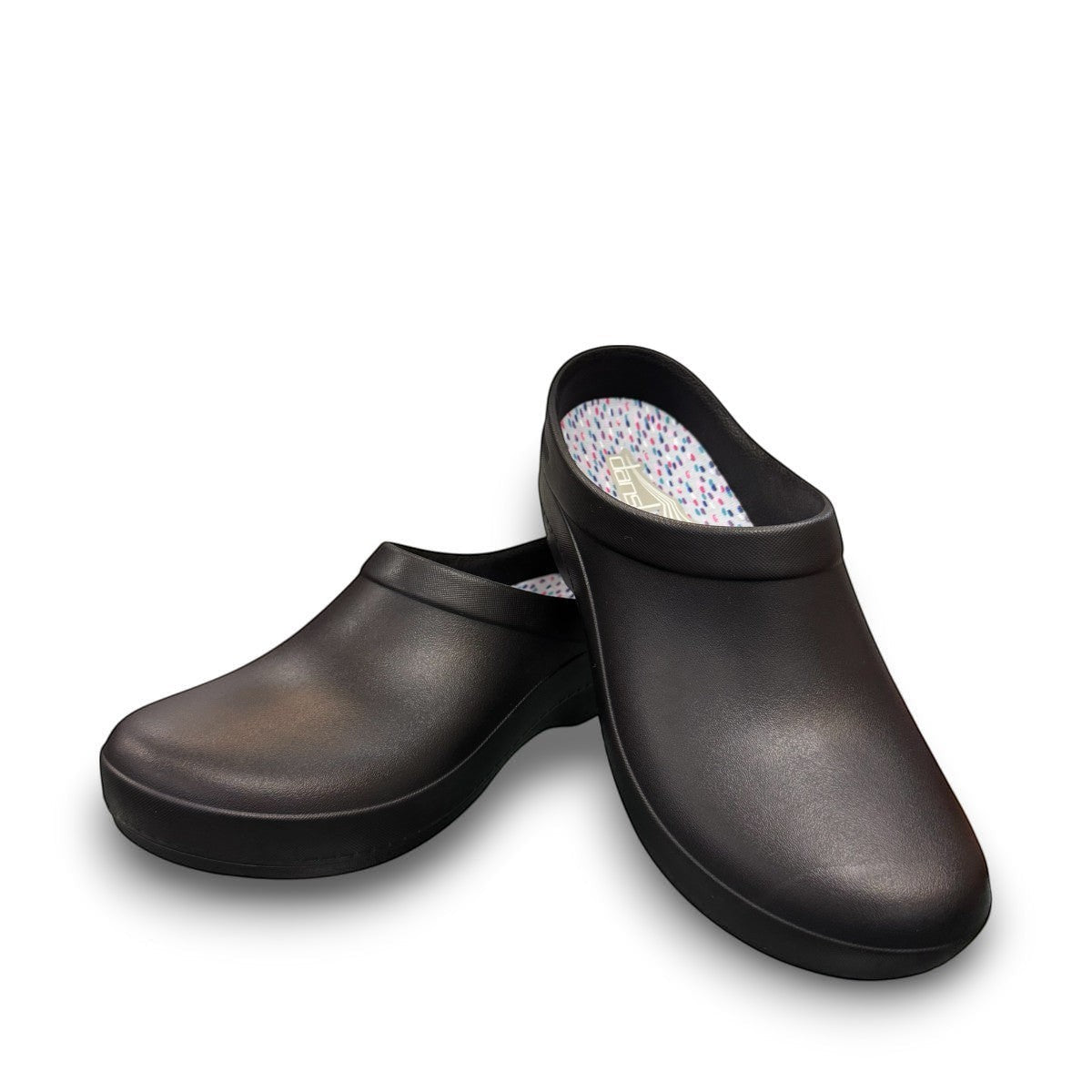 Dansko Kaci black molded EVA clogs showing the slip-resistant rubber outsole tread pattern. Photo of front view.