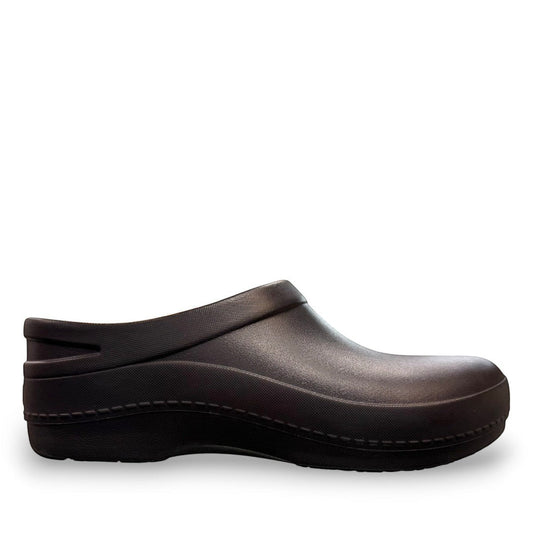 Dansko Kaci black molded EVA clogs showing the slip-resistant rubber outsole tread pattern. Photo of inside side view.