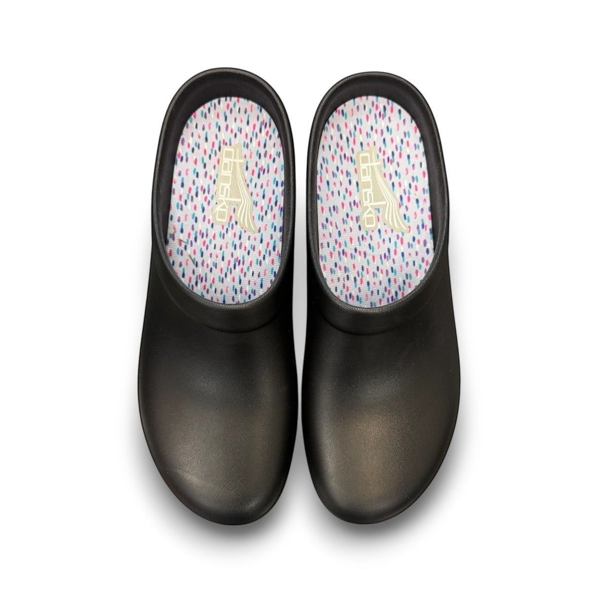 Dansko Kaci black molded EVA clogs showing the slip-resistant rubber outsole tread pattern. Photo of upper view.