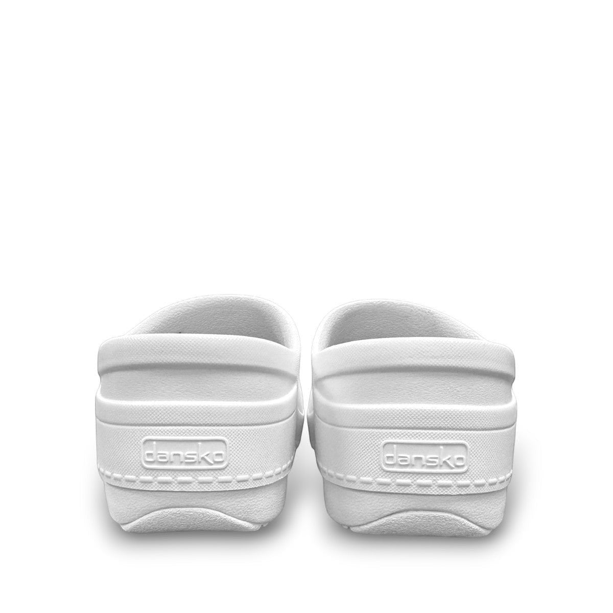 Dansko Kaci white molded EVA clogs showing the slip-resistant rubber outsole and arch support design. Photo of back view.