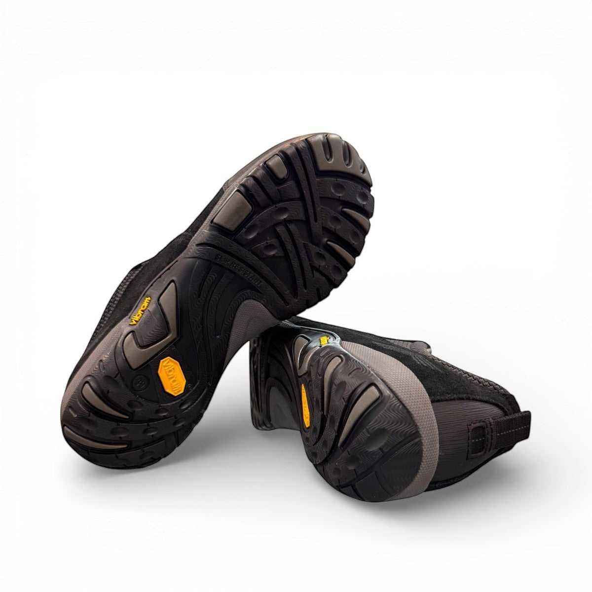 Dansko Paisley black waterproof suede outdoor shoes, slip resistant, showing durable Vibram rubber outsoles. Photo of bottom view.