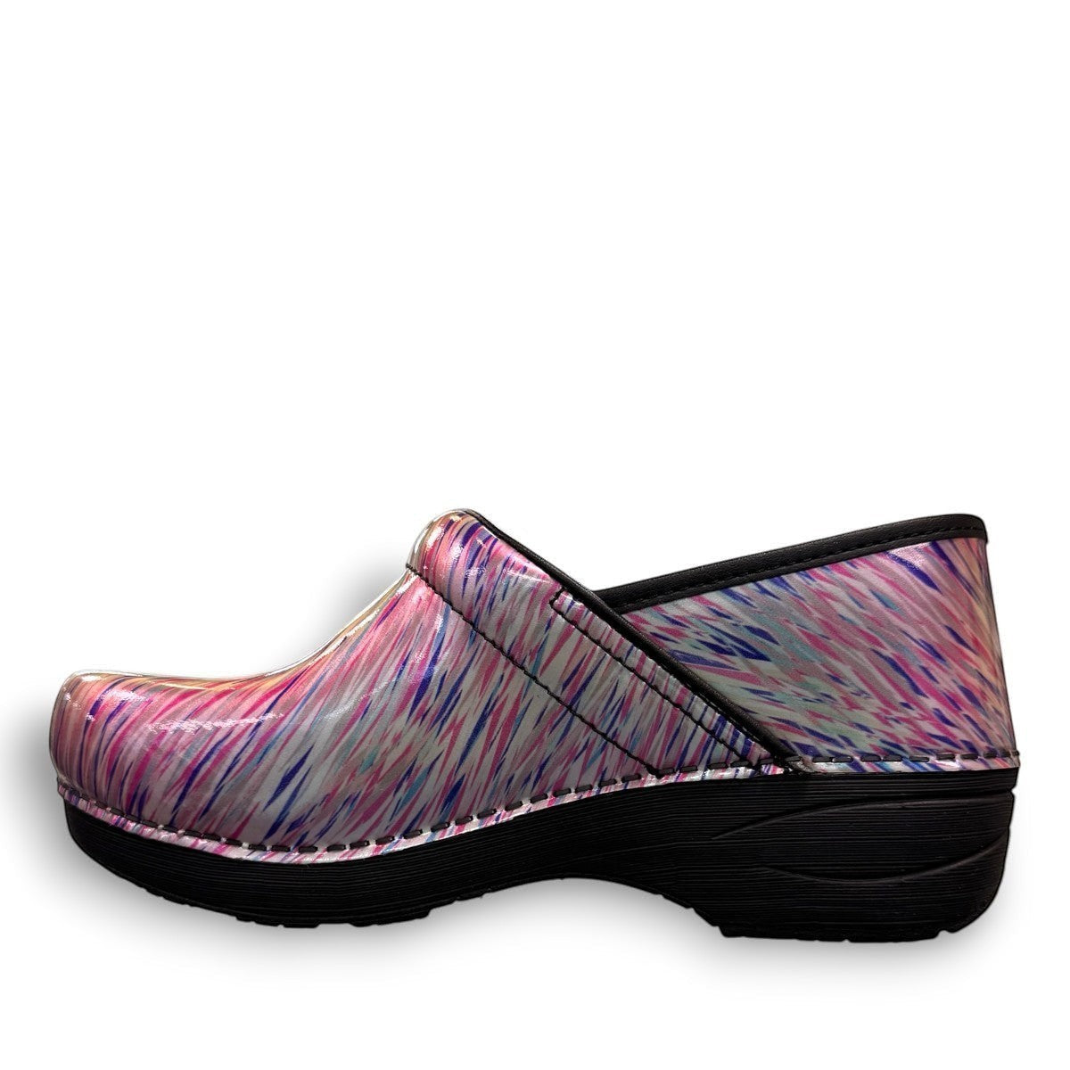 Dansko XP 2.0 patent leather performance clog in a pastel blur multi-color print with black sole. Photo of outside left side view.