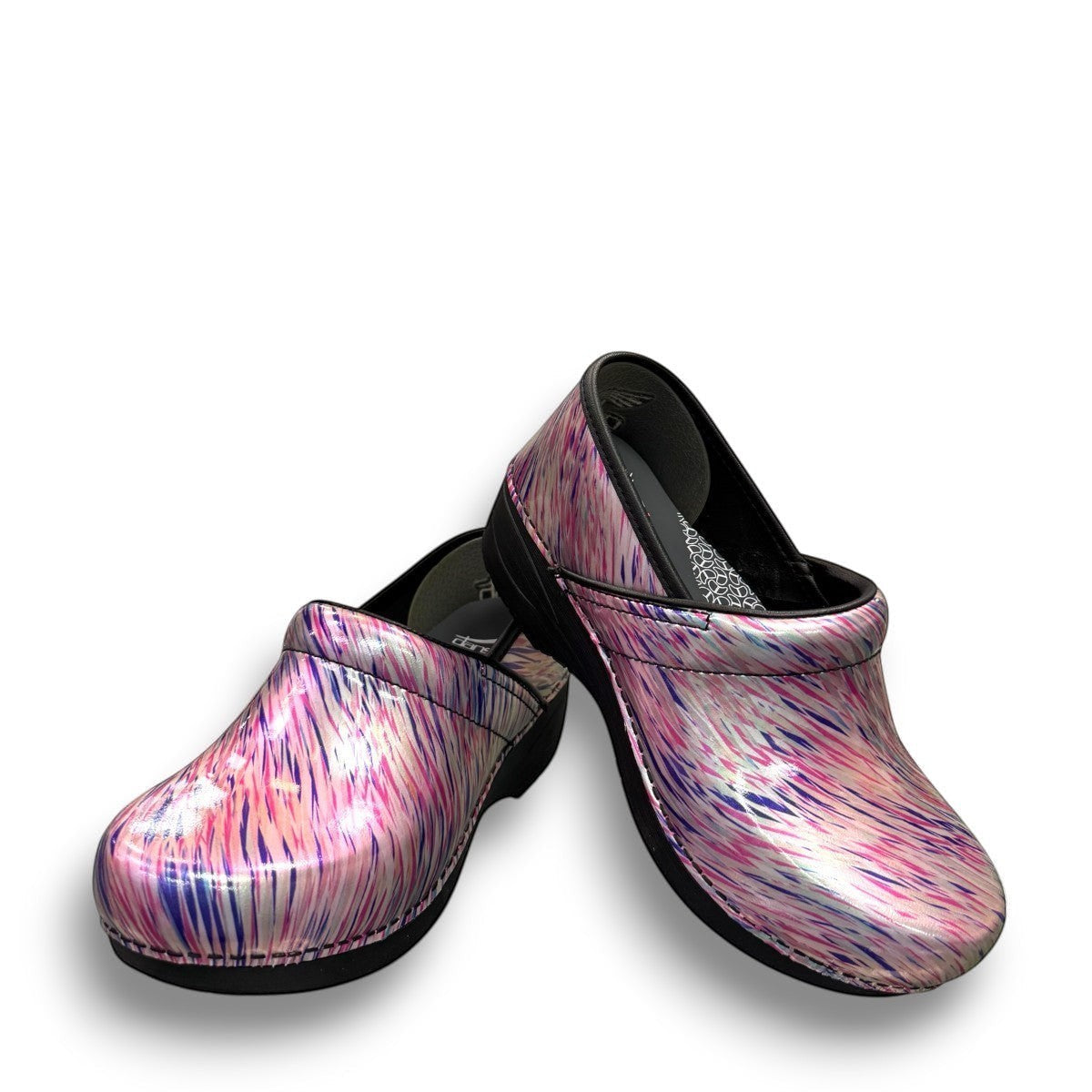 Dansko XP 2.0 patent leather clogs in a pastel blur multi-color print with slip-resistant soles. Photo of front view.