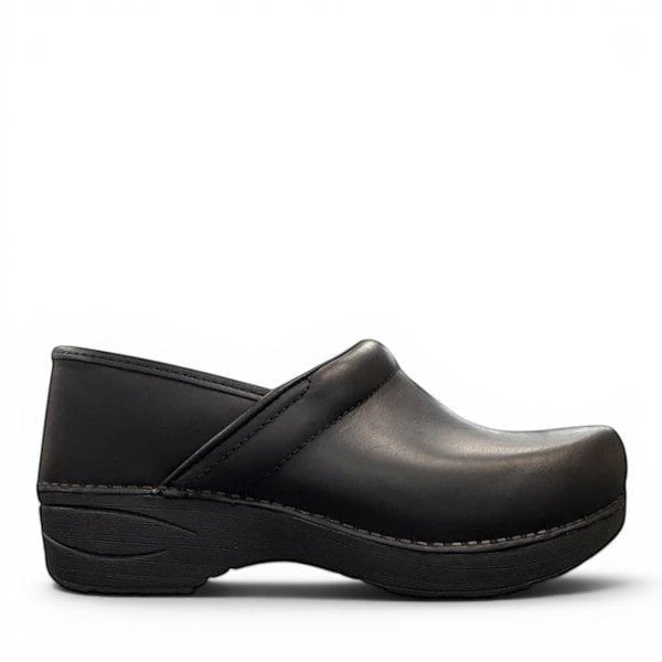 Dansko XP 2.0 black waterproof leather performance clog showing the slip-resistant rubber outsole. Photo of right side view.