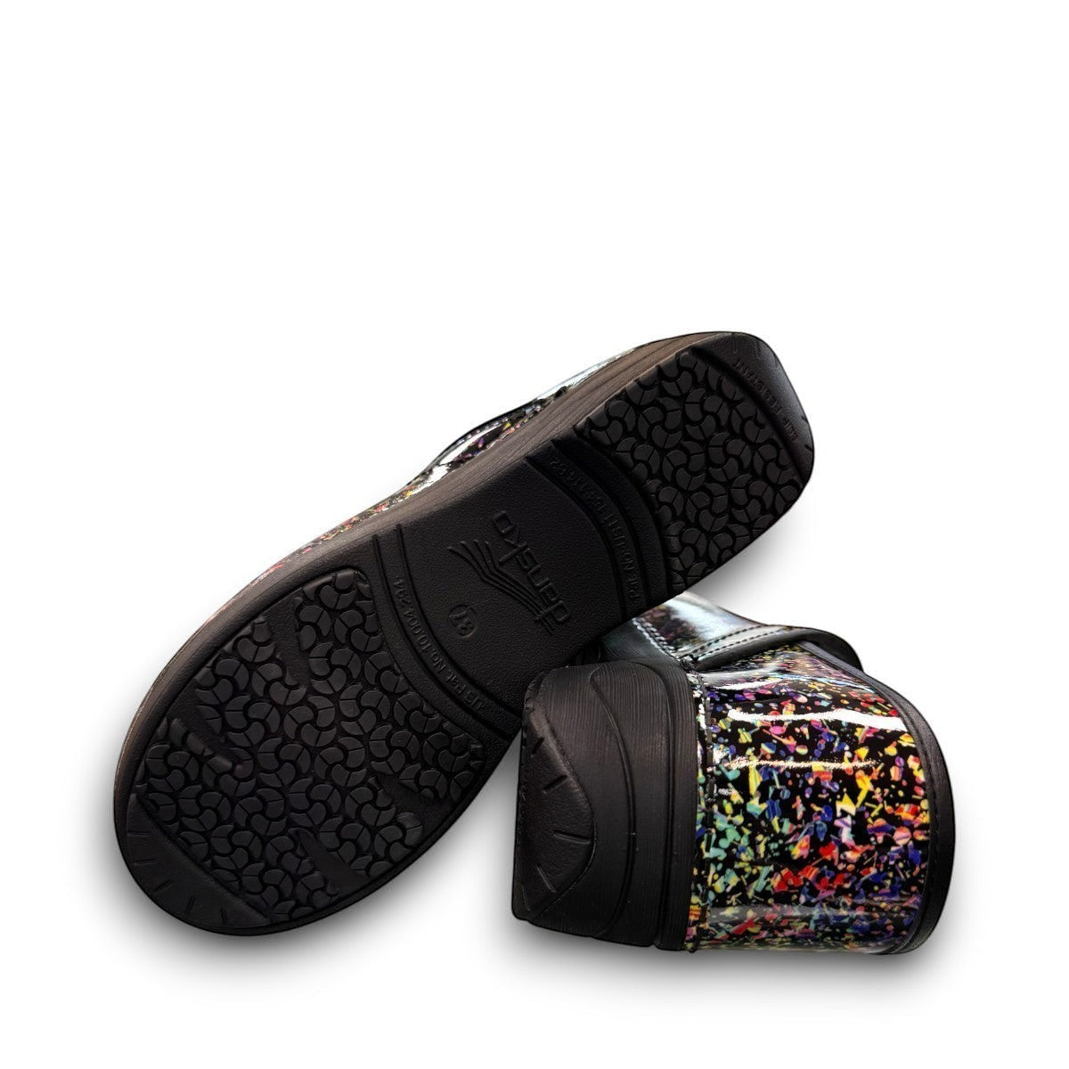 Dansko XP 2.0 patent clog in black with a colorful confetti-like pattern and slip-resistant sole.