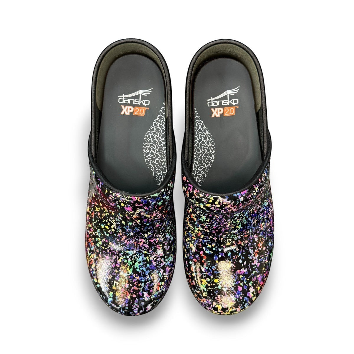 Dansko XP 2.0 patent clog in black with a colorful confetti-like pattern and slip-resistant sole.