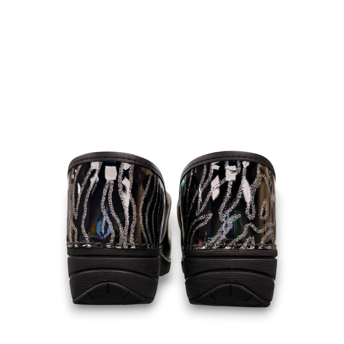 Dansko XP 2.0 patent clog showing the black slip-resistant rubber outsole and glitter wave pattern.