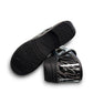 Dansko XP 2.0 patent clog showing the black slip-resistant rubber outsole and glitter wave pattern. Photo of bottom view.