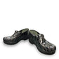 Dansko XP 2.0 patent clog showing the black slip-resistant rubber outsole and glitter wave pattern. Photo of front view at an angle.