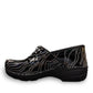 Dansko XP 2.0 patent clog showing the black slip-resistant rubber outsole and glitter wave pattern.
