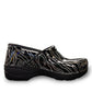 Dansko XP 2.0 patent clog showing the black slip-resistant rubber outsole and glitter wave pattern.