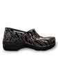 Dansko XP 2.0 patent clog showing the black slip-resistant rubber outsole and glitter wave pattern. Photo of right outside side view.