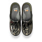 Dansko XP 2.0 patent clog showing the black slip-resistant rubber outsole and glitter wave pattern.