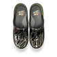 Dansko XP 2.0 patent clog showing the black slip-resistant rubber outsole and glitter wave pattern. Photo of upper view.