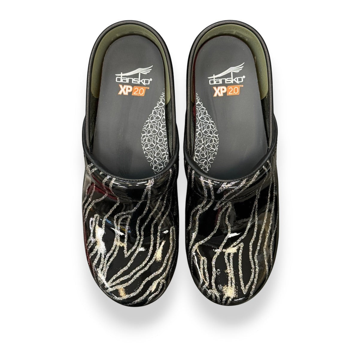 Dansko XP 2.0 patent clog showing the black slip-resistant rubber outsole and glitter wave pattern. Photo of upper view.