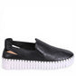 Django & Juliette black leather slip-on sneakers with perforated detail and thick white cleated sole. Photo of right side view.