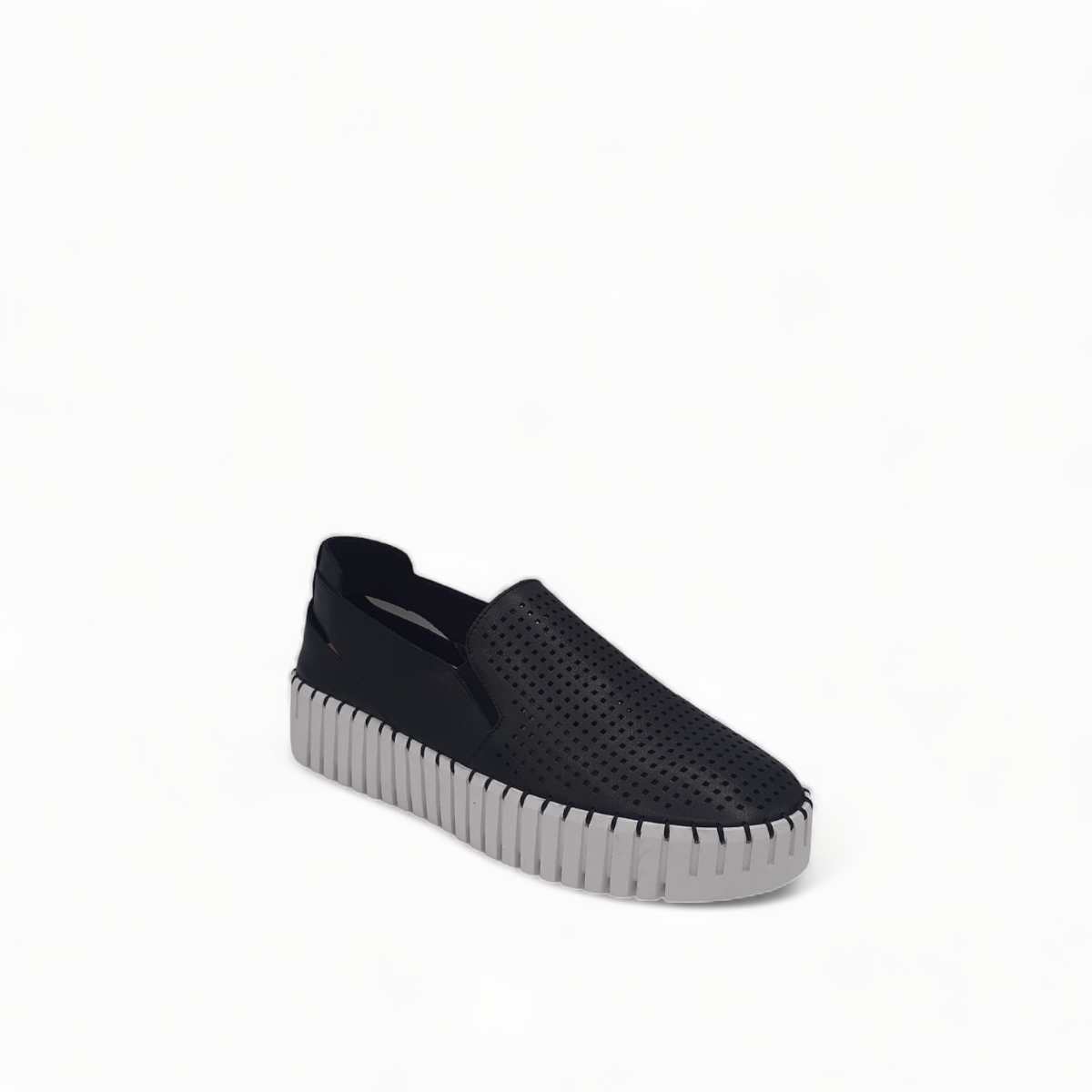 Django & Juliette black leather slip-on sneakers with perforated detail and thick white cleated sole. Photo of front side view.