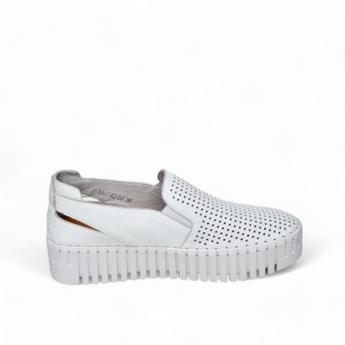 Django & Juliette white leather slip-on sneakers with perforated upper and thick cleated sole. Photo of left side view.