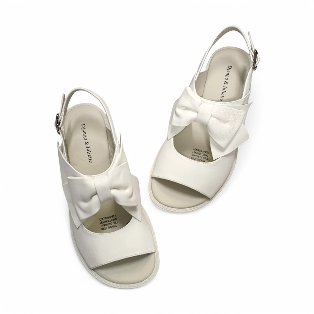 Django & Juliette cream platform sandals with an oversized bow, slingback strap, and chunky lug sole. Photo of upper view.