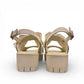 Django & Juliette cream platform sandals with an oversized bow, slingback strap, and chunky lug sole. Photo of back view.