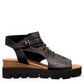 Django & Juliette Rufuss black leather wedge sandals with cut-out design and buckled ankle strap. Photo of right side view.