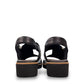 Django & Juliette Kemma black leather platform slides with a silver zip detail and notched sole. Photo of back view.