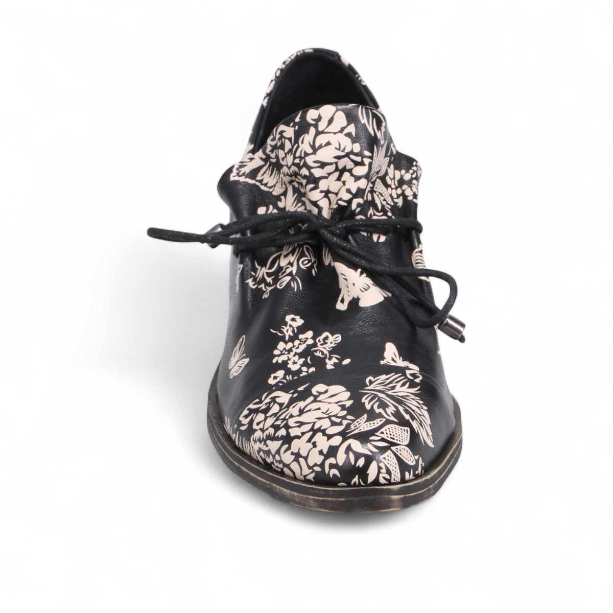 DJANGO & JULIETTE Kotty black and milk floral leather loafer with lace-up detail and rubber outsole. Photo of front view.