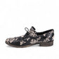 DJANGO & JULIETTE Kotty black and milk floral leather loafer with lace-up detail and rubber outsole. Photo of left side view.