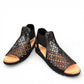 Django & Juliette Montaen black leather platform wedge sandals with laser-cut detailing and ankle strap. Photo of front side view 1.