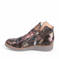 DJANGO & JULIET OHMY ankle boot in blue floral leather with an asymmetrical front zipper and wedge heel. Photo of left side view.