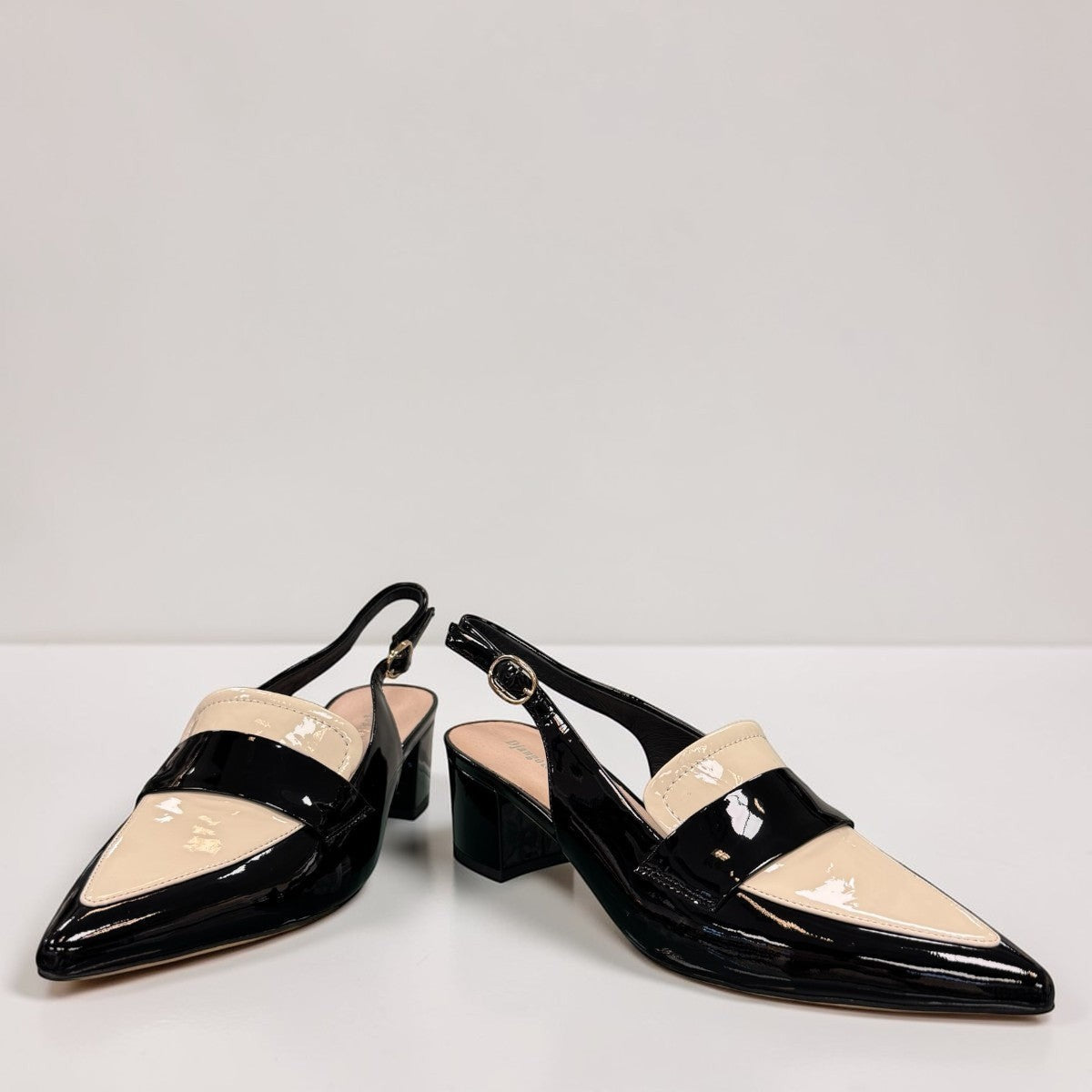 Django & Juliette Aiday black and ivory patent leather slingback block heel shoe with adjustable strap. front view.