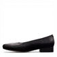 DJANGO & JULIETTE Bavari black leather slip-on heel with a glossy patent toe and low block heel. left view.