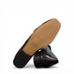 DJANGO & JULIETTE Bavari black leather slip-on heel with a glossy patent toe and low block heel. bottom view.