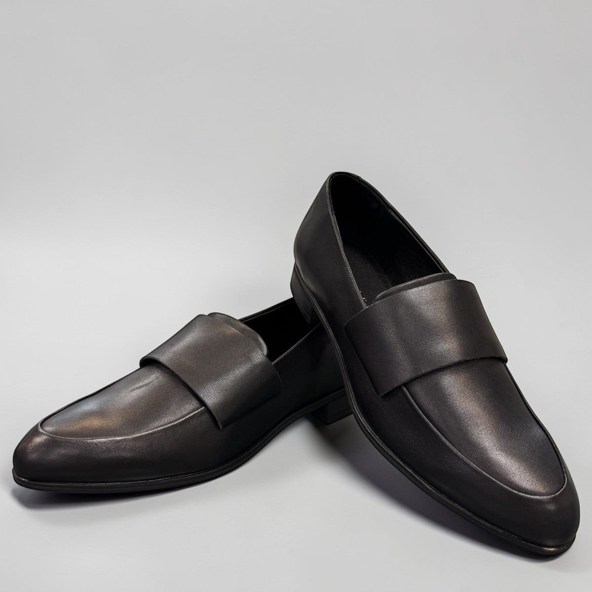 Django & Juliette Gabrian black leather loafers with a low block heel and slip-on design. front view.