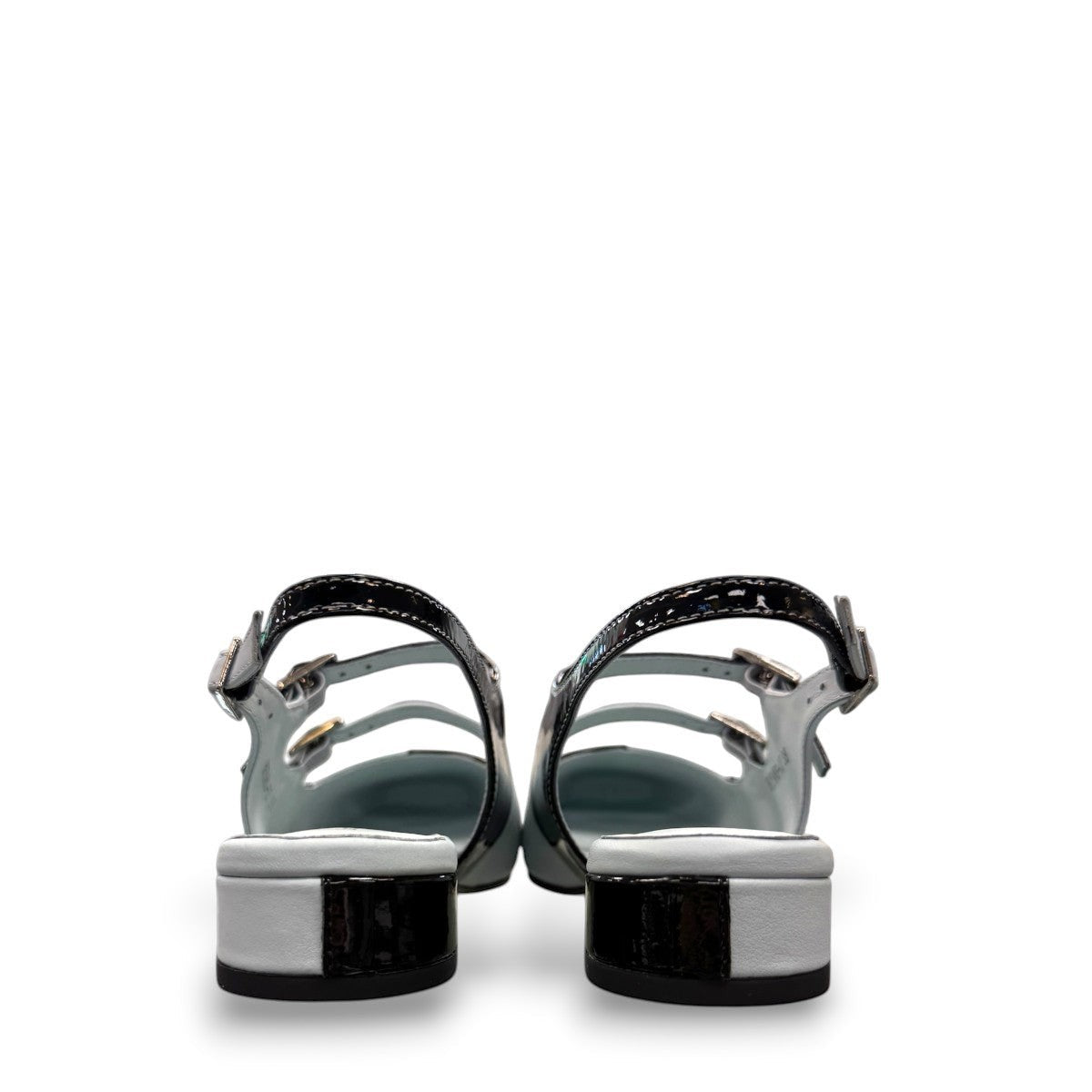 DJANGO & JULIETTE Brynns black and white patent leather slingback Mary Jane flat with buckled straps. back view.