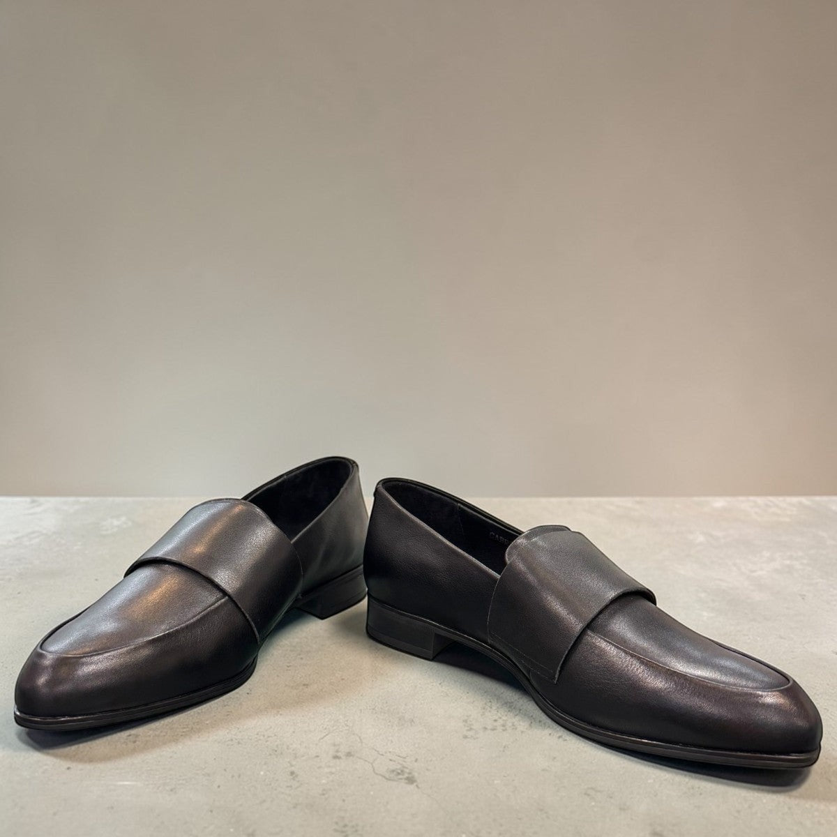 Django & Juliette Gabrian black leather loafers with a low block heel and slip-on design. front view.