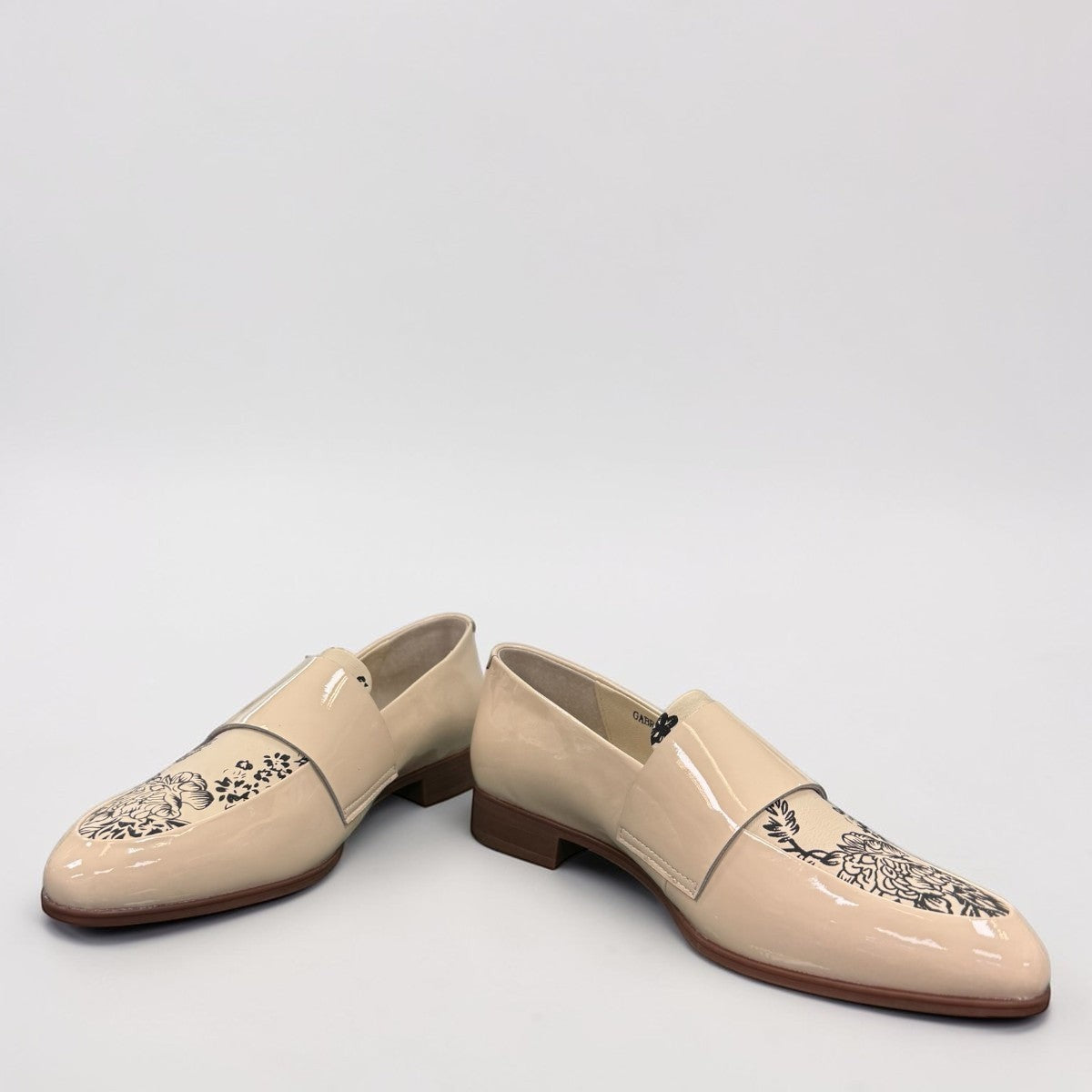 Django & Juliette Gabrian patent leather loafers in milk and black floral print with a low rubber heel. front view.