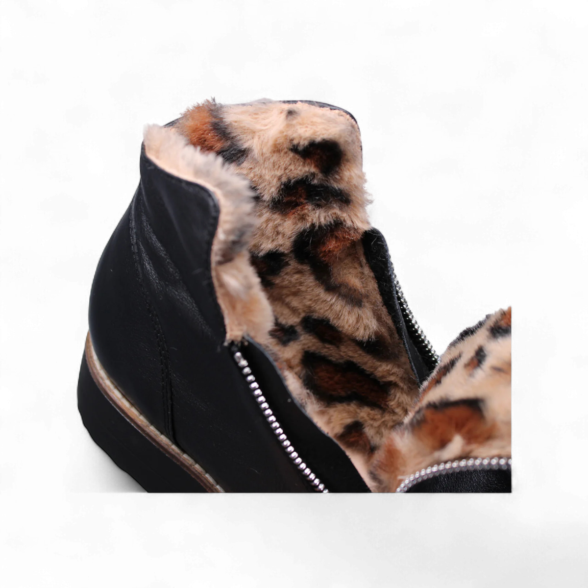 Sina Footwear Django & Juliette Opal black leather flatform wedge bootie with side zipper and fur-lined interior. Photo of the inside sole of fur.
