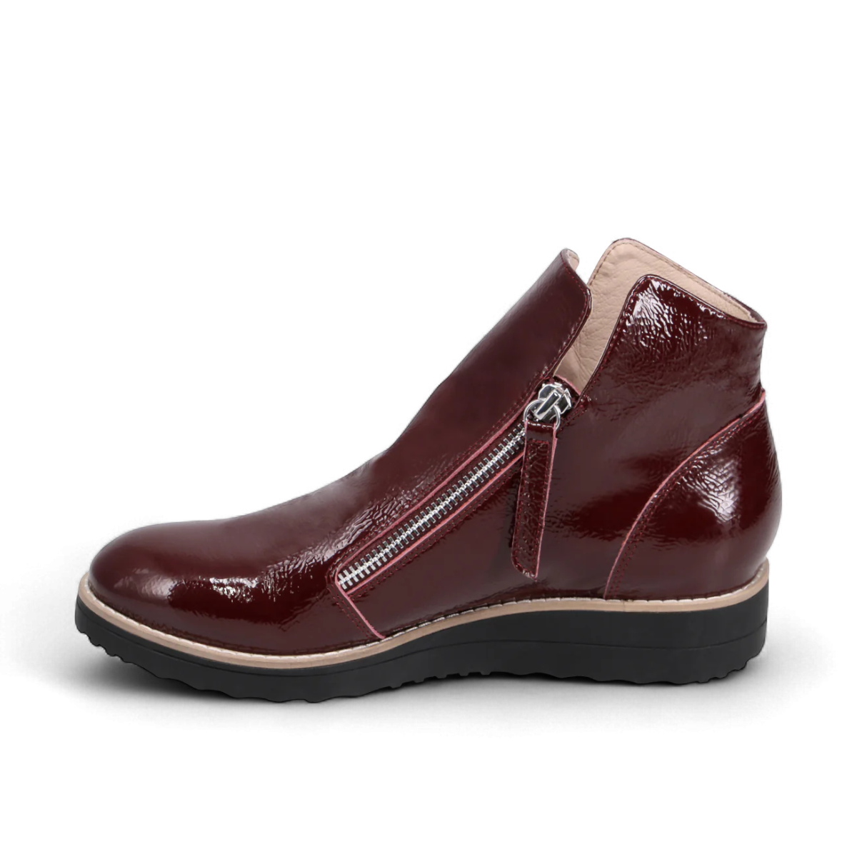 Sina Footwear DJANGO & JULIETTE wine patent leather sneaker-style ankle bootie with twin-zip and black rubber sole. Photo of left side view.