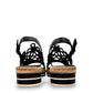 DJANGO & JULIETTE black leather platform sandal with floral cut-outs and woven espadrille trim. back view.